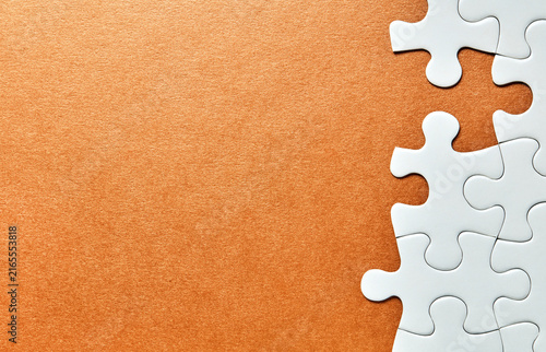 Puzzle pieces along right edge on orange background