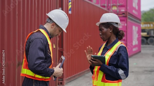 Shipping engineers collaborating with tablets in a logistics yard