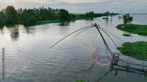 A traditional lift net stands in flooded countryside during the annual water season in An Giang, capturing the tranquil landscape of Vietnam's Mekong Delta.