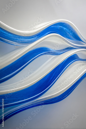 Abstract Blue and White Glass Waves Flowing in a Smooth Motion
