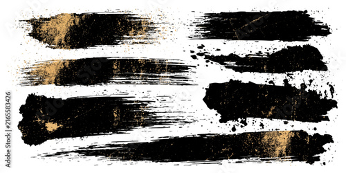 Set of artistic black and gold brush strokes with a textured, grunge effect, perfect for graphic design and abstract backgrounds.