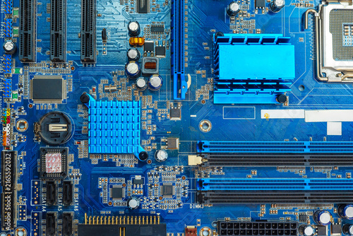 Macro of blue printed circuit board with electronic components and detailed copper traces.