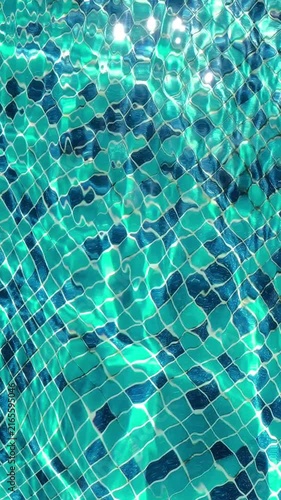 Brilliant sunlight dances through clear turquoise pool water, revealing mosaic tiles beneath dynamic waves, ripples and sparkling reflections. High quality 4k footage