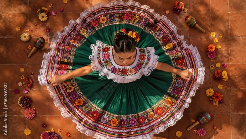Top view of woman dancer in traditional mexican folklorico dress spinning. National Hispanic Heritage Month celebration of latin culture, heritage and folk dance tradition concept.