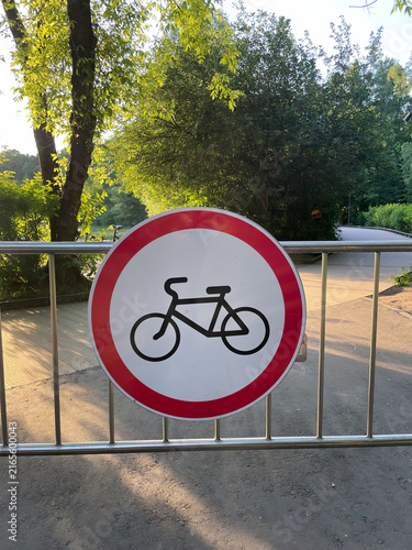 No cycling road sign on metal barrier in a park