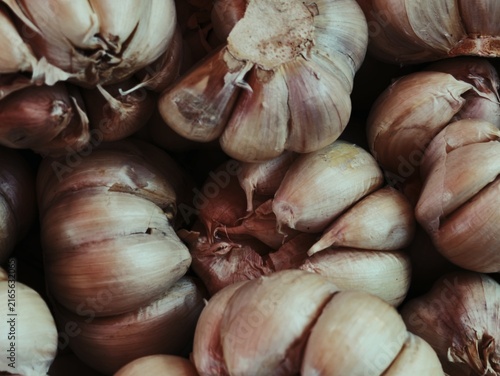 Фотография Full Frame Close Up View of Fresh Garlic Bulbs and Cloves Stacked at Traditional