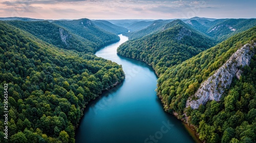 Emerald river carving through verdant mountain landscape