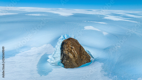 Aerial of the top of a mountain standing out of a glacier, Queen Maud Land, Antarctica