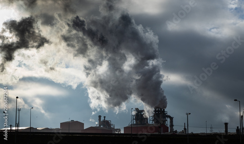 Smoke rises from factory chimneys contributing to pollution in Romania's industrial landscape