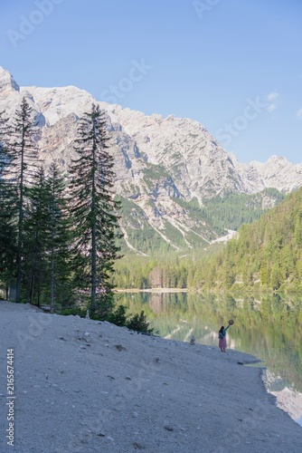 Canvastavla Woman enjoying serene lake Braies in Dolomites Italy
