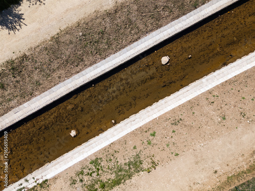 Bild auf Leinwand Drone view shows river management efforts with channel widening and flood prevention features in a rural area during daytime