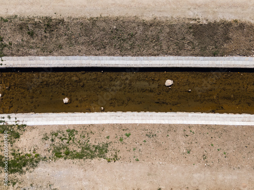 Fotografie The design of river management with raised embankments and reinforced waterways to reduce flood risk