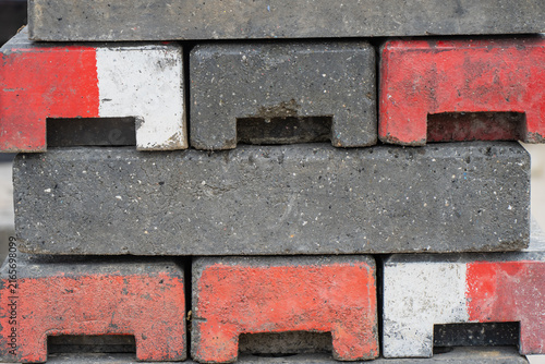 Bild auf Leinwand Precast concrete road barricade blocks stacked for storage with recessed forklif