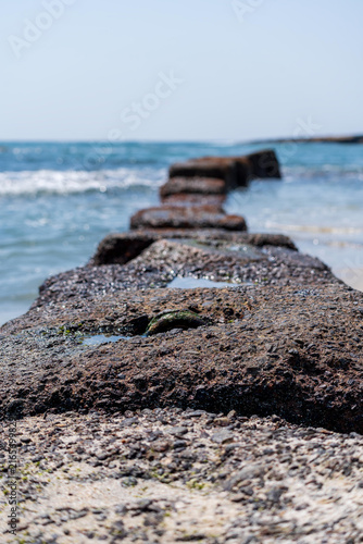 A coastline where rugged, eroded rock formations extend all the way to the sea