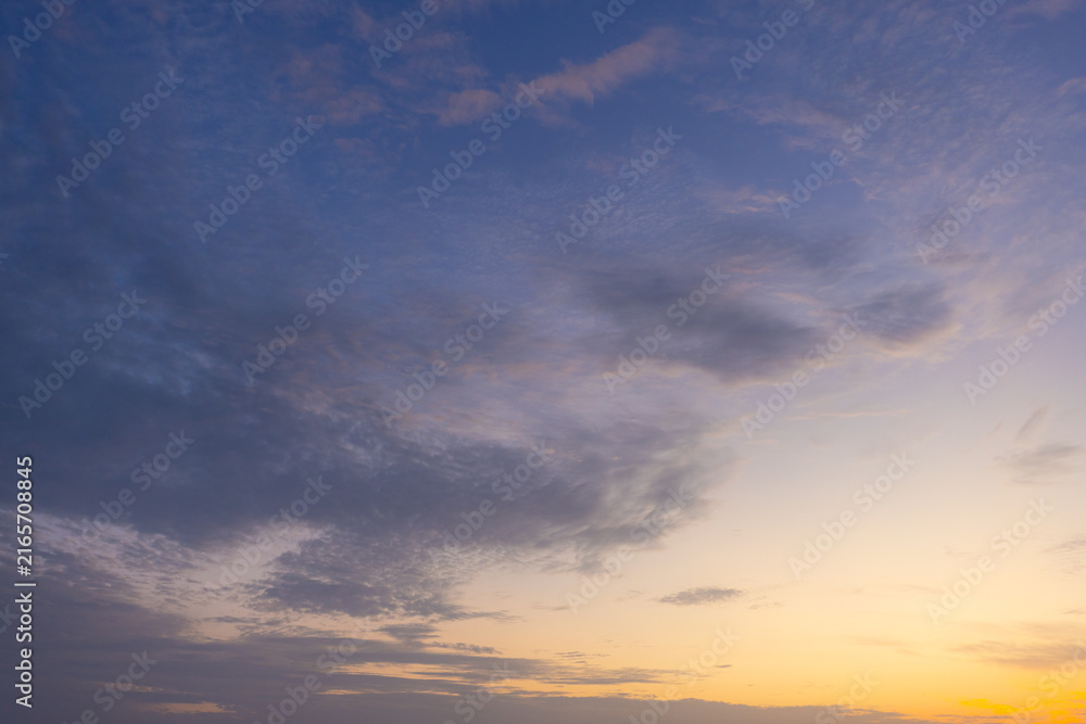 Fototapeta premium Golden Sunrise Sky with Dramatic Clouds and Sunlight,Breathtaking scenic view of a vibrant golden sunrise breaking through a layer of textured altocumulus clouds in the early morning sky, creating.