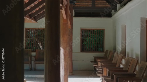 Traditional wooden corridor with chairs inside Wat Phra Lat temple, Peaceful temple interior with timber columns and veranda, Chiang Mai, Thailand 4k