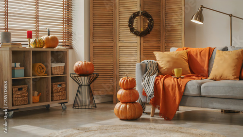 Cozy autumn living room decorated with Halloween pumpkins and warm seasonal decor for festive fall celebration