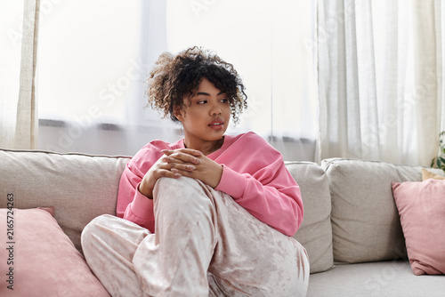 Cuadro en lienzo Relaxing in comfort, a young woman enjoys her serene home environment
