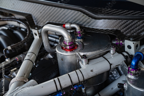 Precision engineered dry sump oil tank and AN hose assembly mounted within a high performance competition vehicle structural engine bay