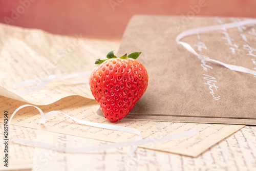 Obraz na plátne Fresh strawberry on vintage handwritten letters with ribbon