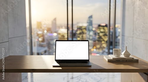 Laptop with Blank Screen on Wooden Desk Overlooking City Skyline at Sunset