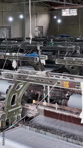 Industrial Textile Mill Interior With Weaving Equipment vertical video