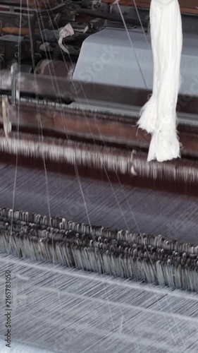 Power Loom Mechanism Weaving White Cloth vertical view