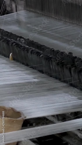 Close-up Of Power Loom Weaving Cotton Fabric vertical view