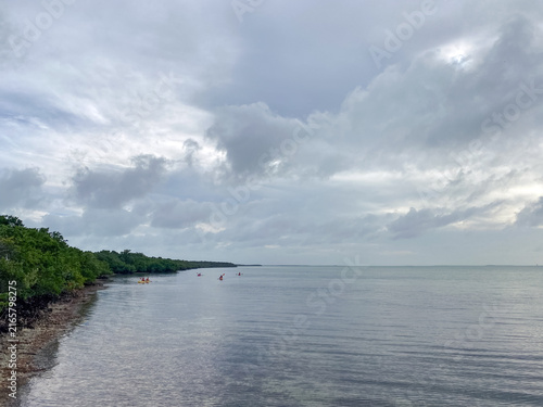 Konstfotografi Cloudy skies over Elliott Key with kayakers in the distance