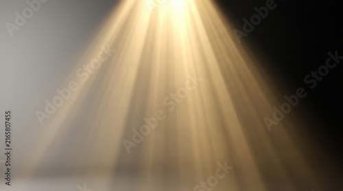 Golden light rays shining down from above against a dark background