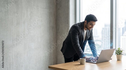 Business professional working remotely on laptop at desk