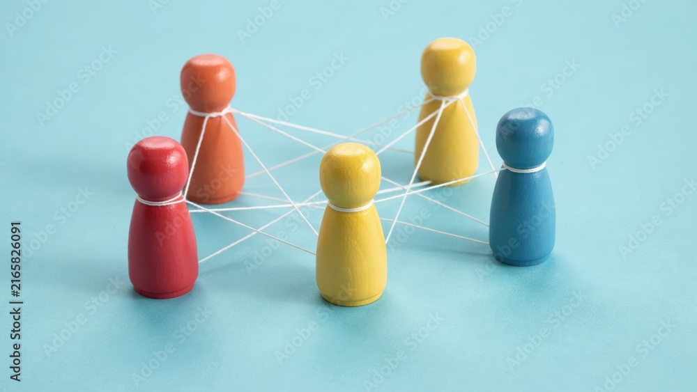 Obraz premium Colorful wooden peg figures connected with white threads on a blue background. Perfect for concepts of teamwork, networking, and social connection.