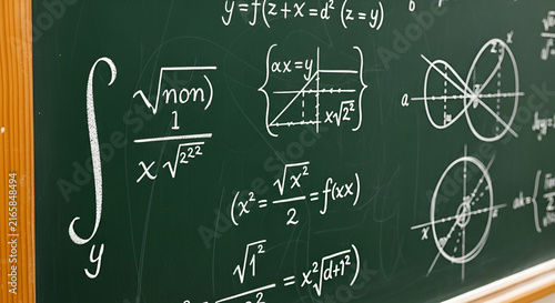 Complex Mathematical Formulas and Algebra Equations Written with White Chalk on a Green Blackboard