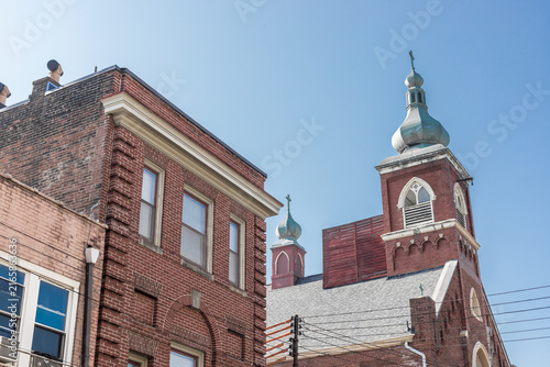 Historic Church Steeples and Brick Buildings Against Blue Sky
