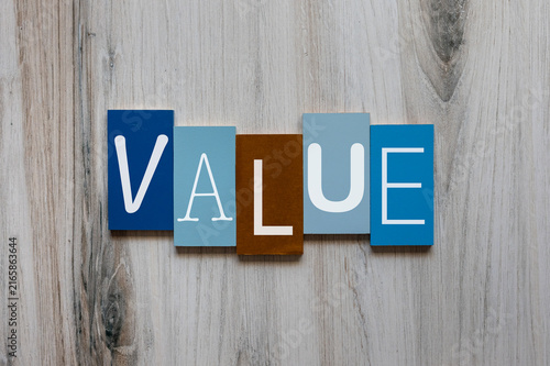 Принти на полотні The word value in white on wooden tiles concept background.