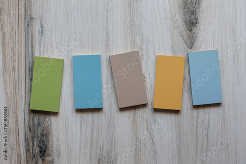 Quadro su tela Photo of blank wooden vertical rectangles light pastel colors laying on wood background