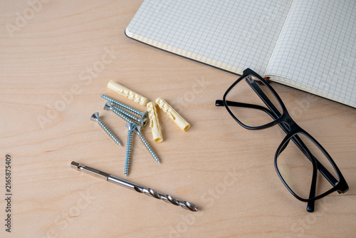 Canvastavla Glasses, notebook, screws, and colorful dowels on plywood