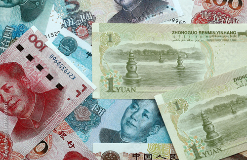 Chinese yuan money banknotes pile on table. China bills of CNY currency close up. Concept of economy
