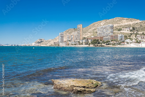 Coastal Mediterranean Beach with Modern Buildings and Mountains