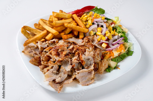 Canvastavla Kebab plate with shaved roasted meat, French fries and fresh mixed salad with co