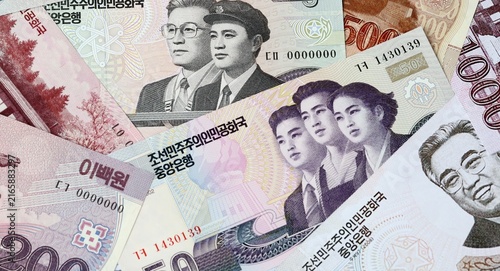 North Korean won money bills in pile on table. North Korea KPW currency cash close up