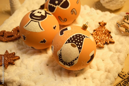Christmas balls for decorating a Christmas tree or room design. beautiful balls on the background of a Christmas tree with a glowing garland. deer, gnome and gingerbread man smiling in the new year