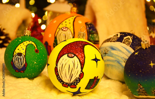 Christmas balls for decorating a Christmas tree or interior. beautiful balls on the background of a Christmas tree with a glowing garland. gnomes with a beard and a cap smile on New Year's Eve