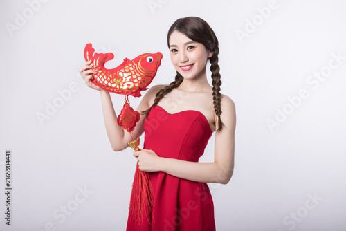 Fotografie Young woman holding Chinese lucky fish decoration for Lunar New Year