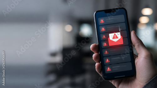 Concept of cybersecurity risk and phishing attack with smartphone showing spam messages and malware warning