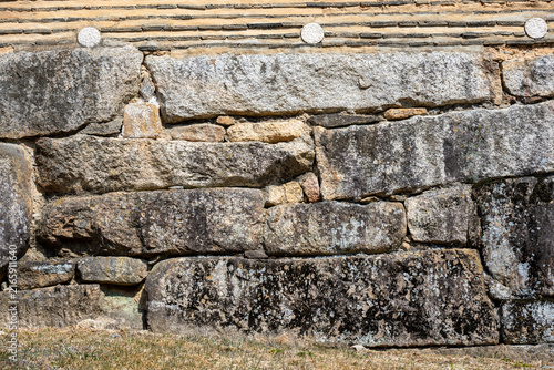 Aged granite stone terrace wall and traditional clay tile fence at historic temple in South Korea.