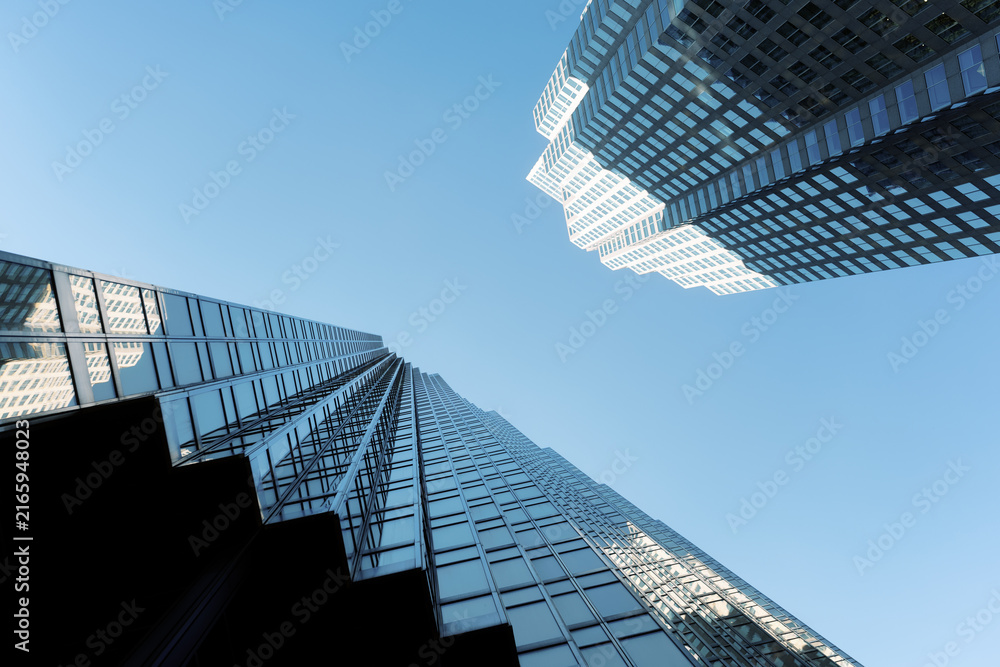 Fototapeta premium Modern glass skyscrapers in downtown financial district viewed from below