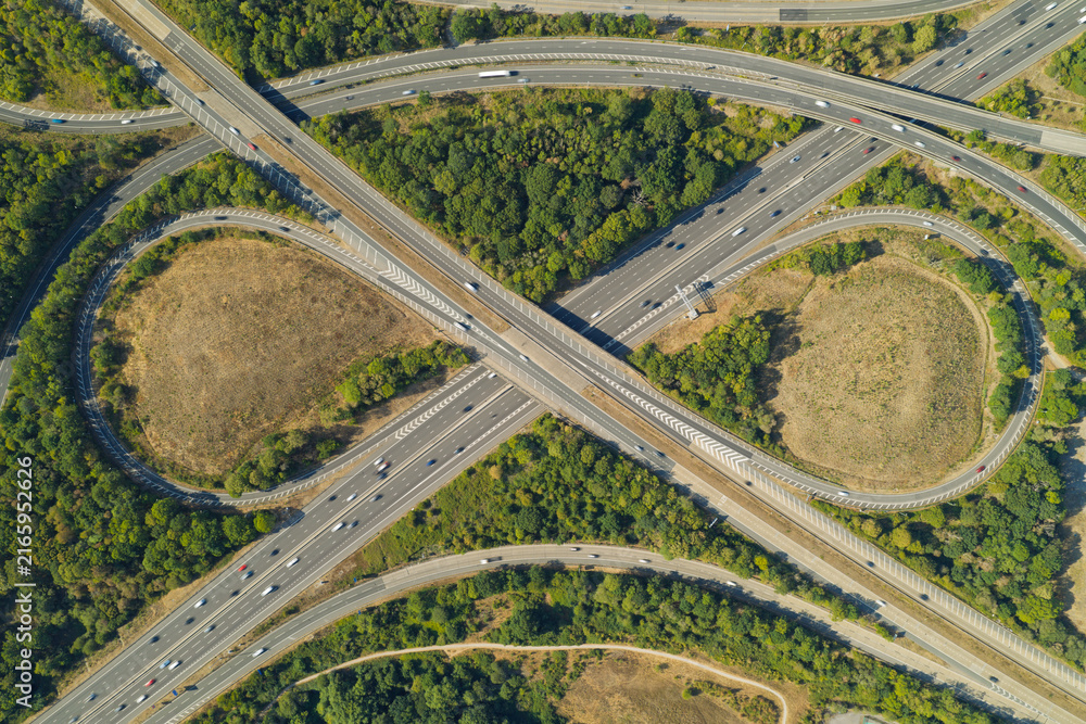 Fototapeta premium Aerial View of Highway Intersection With Cars Driving on Asphalt Roads During Daytime