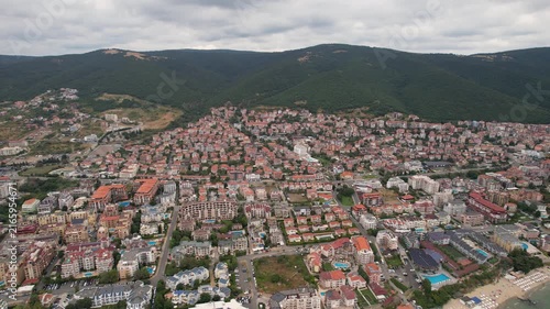 Aerial drone view of houses with red tiles and hotels, sea and beaches of Sveti Vlas in Bulgaria from above, top view from drone. Summer holiday in Europe. Black sea
