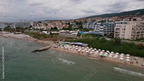 Aerial drone view of houses with red tiles and hotels, sea and beaches of Sveti Vlas in Bulgaria from above, top view from drone. Summer holiday in Europe. Black sea
